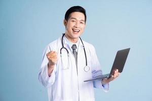 Asian male doctor portrait on blue background photo