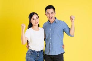 image of asian couple posing on yellow background photo