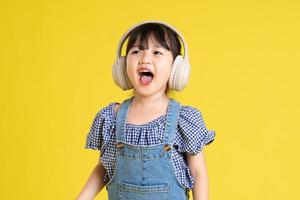 beautiful asian girl portrait, isolated on yellow background photo