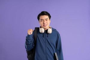 Asian male student portrait on purple background photo