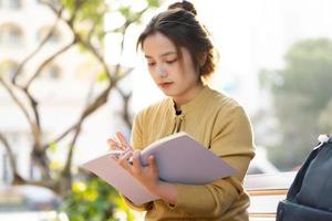 Portrait of a beautiful Asian female student at university photo