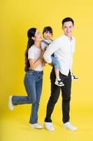 happy asian family image, isolated on yellow background photo