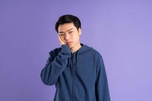 portrait of asian man posing on purple background photo