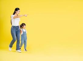 image of asian mother and daughter posing on a yellow background photo