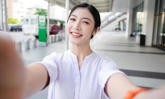 Happy smiling young woman on the street photo