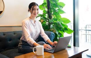 Portrait of beautiful asian woman sitting at cafe photo