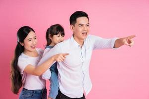 young asian family image isolated on pink background photo