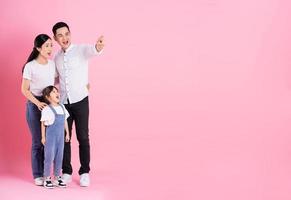 young asian family image isolated on pink background photo