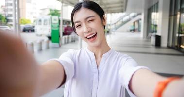 Happy smiling young woman on the street photo