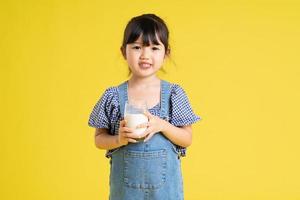beautiful asian girl portrait, isolated on yellow background photo