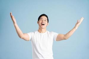 Asian male portrait posing on blue background photo