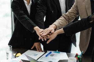 image of a group of business people holding hands together to show determination photo