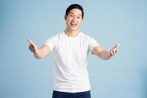 Asian male portrait posing on blue background photo