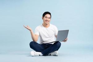 portrait of asian man posing on blue background photo