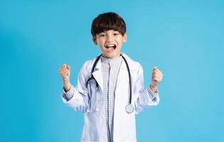 Asian boy portrait posing on blue background photo