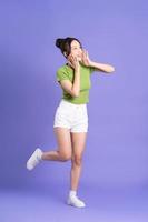 full body image of beautiful asian girl posing on pink background photo