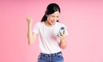 hermoso retrato de una chica asiática, aislado de fondo rosa foto