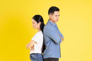 image of asian couple posing on yellow background photo