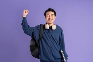 Asian male student portrait on purple background photo