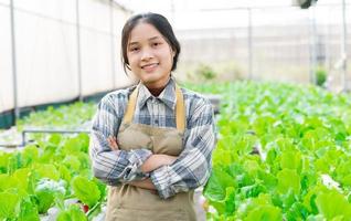 image of asian female farmer in her hydroponic vegetable garden photo
