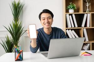 image of Asian man sitting at home working photo