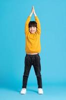 full body image of asian boy posing on blue background photo