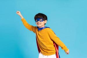 The image of a boy wearing a cape transforms into a hero photo