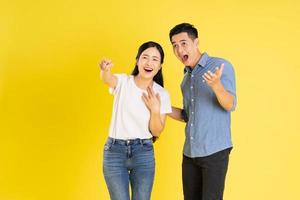 image of asian couple posing on yellow background photo