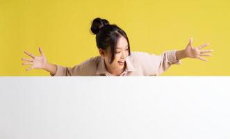 image of asian girl standing and posing with billboard photo