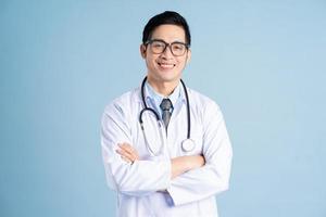 Asian male doctor portrait on blue background photo