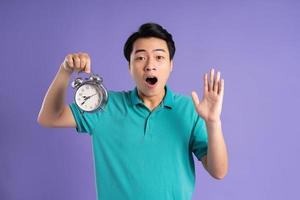 portrait of asian man posing on purple background photo