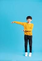 full body image of asian boy posing on blue background photo