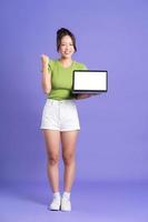 full body image of beautiful asian girl posing on pink background photo