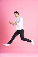 Asian man full body image, isolated on pink background photo