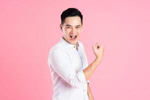 portrait of asian man posing on pink background photo