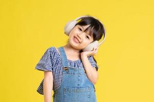 beautiful asian girl portrait, isolated on yellow background photo