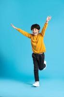 full body image of asian boy posing on blue background photo