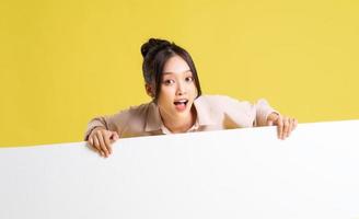 image of asian girl standing and posing with billboard photo