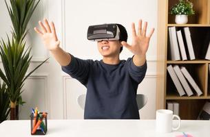 portrait of asian man using virtual reality glasses photo