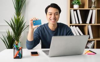 image of Asian man sitting at home working photo