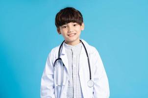 Asian boy portrait posing on blue background photo