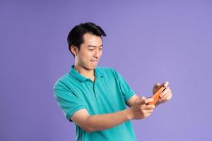 portrait of asian man posing on purple background photo