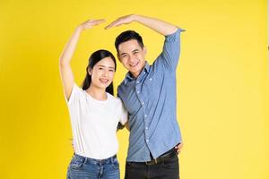 image of asian couple posing on yellow background photo