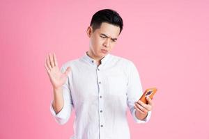 portrait of asian man posing on pink background photo