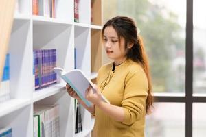 portrait of Asian female student studying at university library photo