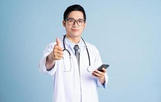 Asian male doctor portrait on blue background photo