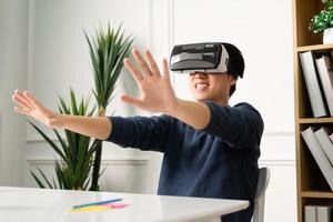 portrait of asian man using virtual reality glasses photo