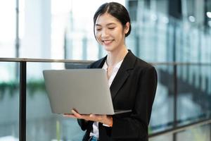 retrato de un hermosa joven asiático mujer de negocios a el empresa foto