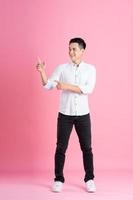 Asian man full body image, isolated on pink background photo