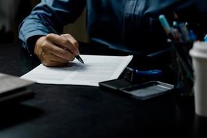 businessman agree to make deal signing document, sale contract or legal transaction contract at desk photo